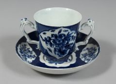 A BOW CHOCOLATE CUP AND SAUCER, the cup of flared beaker shape with two ornately moulded handles,