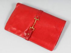 GUCCI. A RED CLUTCH BAG. 10ins.