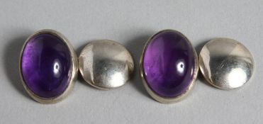 A PAIR OF SILVER AND AMETHYST CUFF LINKS.