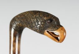 A CARVED WOOD EAGLE'S HEAD WALKING STICK.