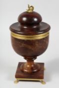 A REGENCY STAINED ALABASTER URN AND COVER with hinged lid on claw feet.