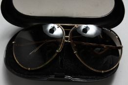 A PAIR OF PORSCHE SUNGLASSES in a case.