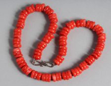 A CORAL SWEETIE STYLE BEAD NECKLACE. 17ins long.