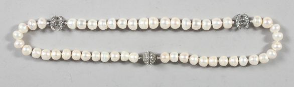 A GOOD CHANEL PEARL AND DOUBLE 'C' NECKLACE. 48 pearls, 24ins long in a black Chanel box..