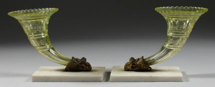 A GOOD PAIR OF GLASS CORNUCOPIA VASES with ram's masks and marble bases