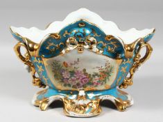 A LARGE DRESDEN STYLE BLUE PORCELAIN OVAL SHAPED TWO HANDLED BOWL edged in gilt and painted with