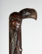 AN UNUSUAL WALKING STICK with a Chinese man's head and bird's head.