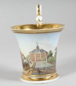 A SMALL MEISSEN CUP painted with a scene of Leipzig. Inscribed Leipzig, cross swords mark in blue.