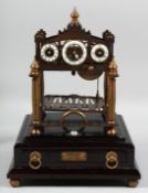 A ROLLING BALL CLOCK in a glass cover. 15ins diameter.