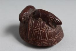 A JAPANESE CARVED WOOD NETSUKE, rats on shell. 1.25ins