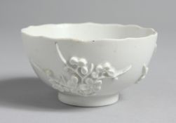 A GOOD EARLY BOW BLANC DE CHINE PETAL EDGED TEA BOWL with applied sprigs of prunus incised line to