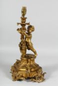 A GOOD 19TH CENTURY FRENCH ORMOLU CUPID LAMP with fruiting vines and scrolls. 16ins.