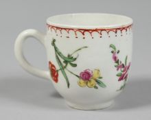 A BOW COFFEE CUP painted with coloured flowers under a line, dot and loop border.