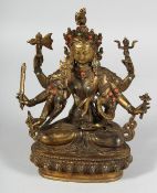 A CHINESE BRONZE GOD siting, with coral and turquoise. 8.5ins high.
