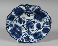 A BOW OVAL DISH moulded with grape leaves and painted in underglaze with grapes and vine.
