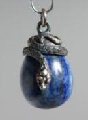 A RUSSIAN SILVER AND ENAMEL EGG PENDANT with snake.