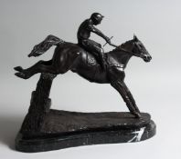 A BRONZE HORSE AND JOCKEY over the sticks, on a marble base.