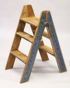 A PAIR OF NOVELTY ADVERTISING PINE STEPS. 2ft 8ins high.