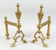 A PAIR OF VICTORIAN BRASS ANDIRONS with urn finials and claw feet. 13ins high.