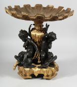 A GOOD GILT BRONZE AND BRASS CUPID COMPORT supported by three cupids.