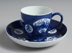 A BOW POWDER BLUE COFFEE CUP AND SAUCER painted with landscapes in fan shaped panels.