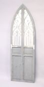A RUSTIC ARCH SHAPED GARDEN MIRROR with grey painted decoration. 5ft 11.5ins high x 1ft 10.5ins