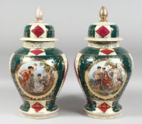 A LARGE PAIR OF VIENNA BULBOUS VASES AND COVERS painted with figures in a classical panel. 17ins