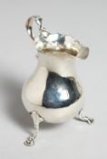 A GEORGE III SILVER CREAM JUG.