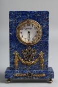 A SUPERB RUSSIAN LAPIS CLOCK mounted with precious stones, Russian eagle and garlands. 4ins high x