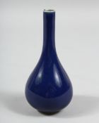 A DARK BLUE PORCELAIN VASE with a long neck. 6ins high.