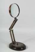 A MAGNIFYING GLASS on a stand.