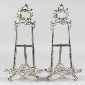 A PAIR OF SILVERED EASELS 15ins
