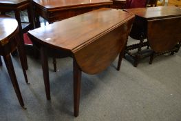 A mahogany drop-leaf dining table.