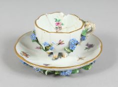 A SMALL MEISSEN FLOWER ENCRUSTED TEACUP AND SAUCER. Mark in blue, (cup A/F).
