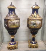 A SUPERB LARGE PAIR OF 19TH CENTURY SEVRES PORCELAIN URNS AND COVERS, rich blue ground with gilt