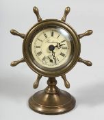 A SMALL BRASS SHIP'S WALL CLOCK. 6ins high.