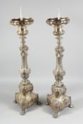 A GOOD PAIR OF CONTINENTAL SILVER PLATE PRICKET CANDLESTICKS. 30ins high.