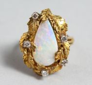 A GOOD 18CT GOLD TIER DROP OPAL AND DIAMOND RING.