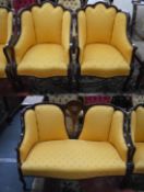 A pair of Edwardian inlaid mahogany framed armchairs with shaped backs on cabriole legs, upholstered