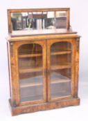 A GOOD VICTORIAN WALNUT PIER CABINET with mirrored top, glass panel doors and sides, enclosing three