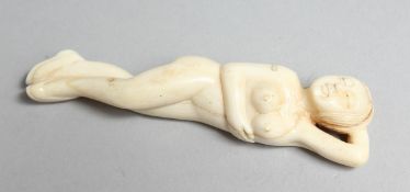 A CARVED BONE DOCTOR'S NUDE FIGURE. 3.5ins long.
