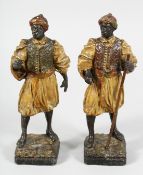 A PAIR OF 19TH CENTURY AUSTRIAN PAINTED NUBIAN STANDING FIGURES. 9ins high.