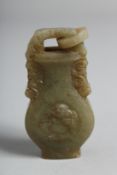 A CHINESE CARVED JADE URN with ring handles.