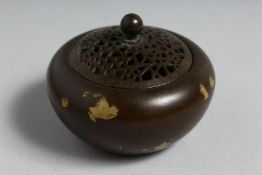A CHINESE PIERCED TOP GOLD SPLASH CENSER. Signed. 2.75ins diameter.