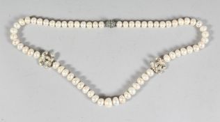 A GOOD CHANEL PEARL AND DOUBLE 'C' NECKLACE. 65 pearls, 28ins long in a black Chanel box.