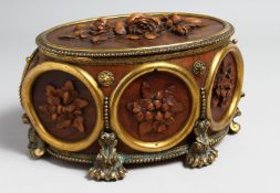 A RARE BLACK FOREST OVAL CARVED WOOD AND GILT JEWEL BOX the top with large floral carved wood