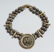 A DOUBLE ROW BEAD NECKLACE with lion pendant.