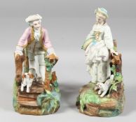 A CONTINENTAL BISQUE FIGURE a man and a dog on a rustic bridge, a young lady by a fence.