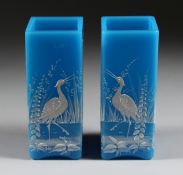 A GOOD PAIR OF BLUE MILK GLASS VASES enamelled with storks and flowers. 6.5in high.