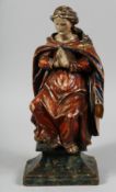 AN 18TH CENTURY, POSSIBLY ITALIAN, CARVED POLYCHROME FIGURE of a praying saint. 15ins high.